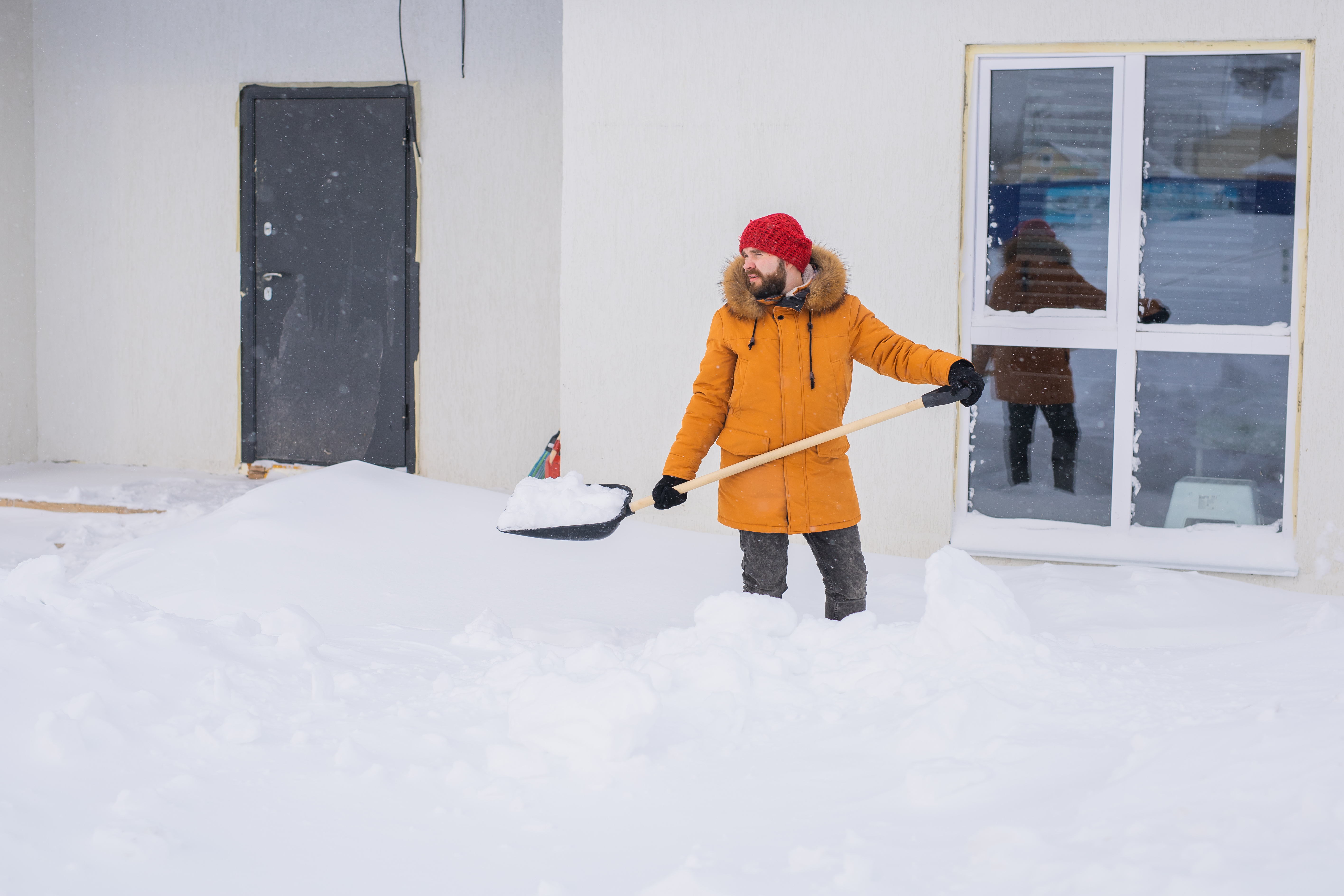 bearded man clearing snow